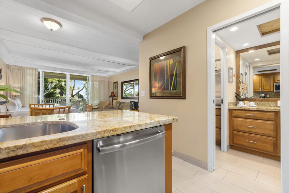 Your fully-equipped kitchen flows seamlessly into a sunlit living area and overlooks tropical greenery—perfect for unwinding after a day of island adventures.