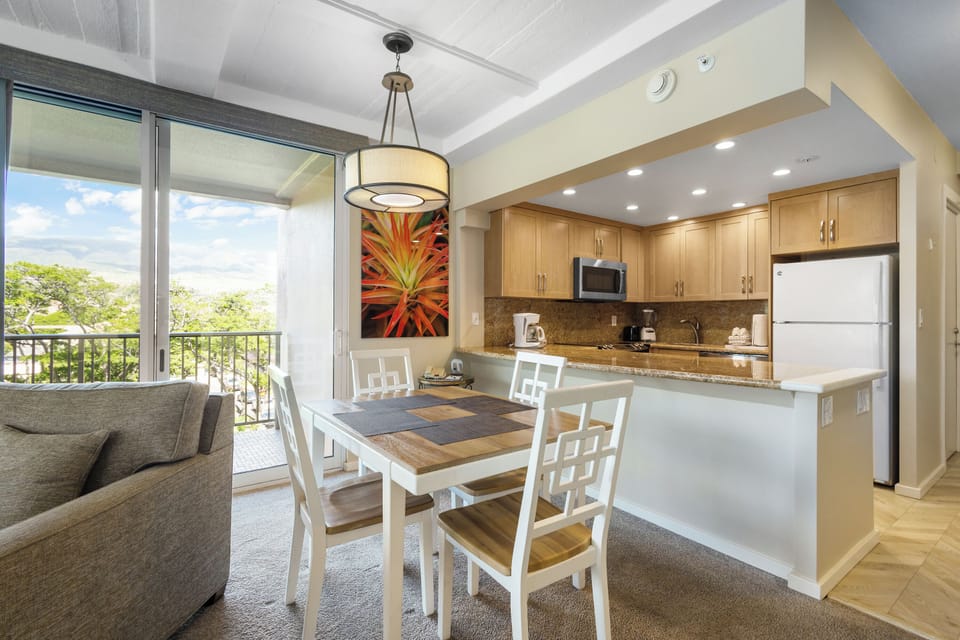 Gather around your dining table with a view of lush greenery, then step into your fully equipped kitchen where granite counters and modern appliances make meal prep a breeze.