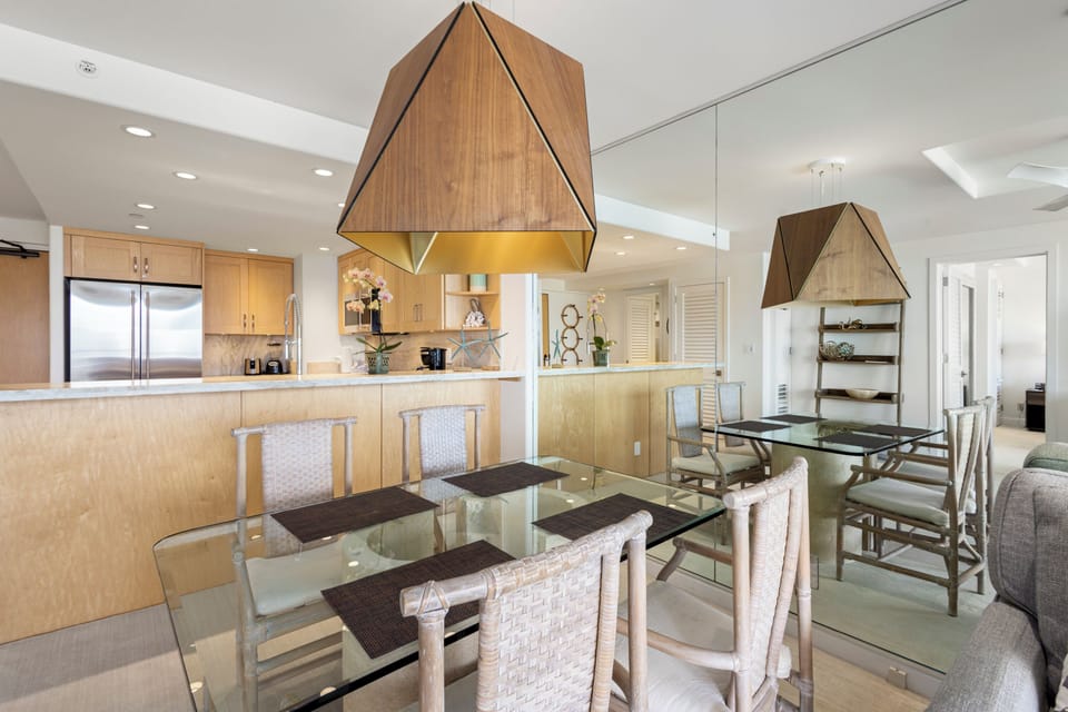 Gather around your sleek glass dining table beneath stunning geometric pendant lights, while the chef in your group enjoys the open-concept kitchen with modern appliances and ample counter space.