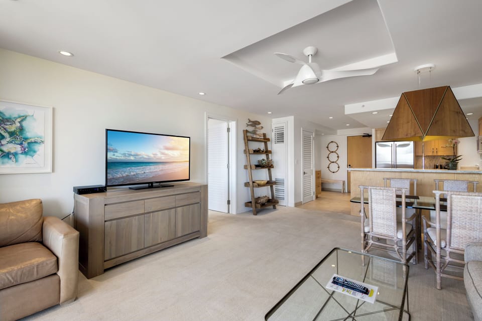 Your bright, open-concept retreat blends relaxation and function—unwind on the sofa, gather at the dining table, or prep meals in the modern kitchen, all bathed in coastal light.
