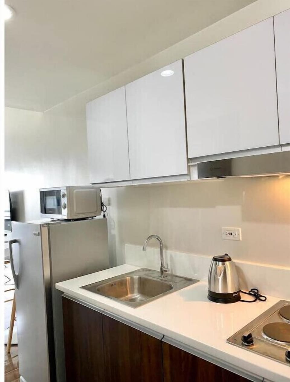 Kitchen equipped with 2 burner electric stove.