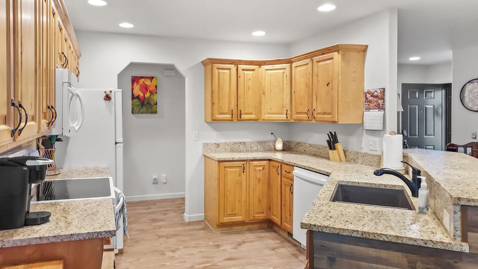 Spacious kitchen with over, refrigerator, and dishwasher