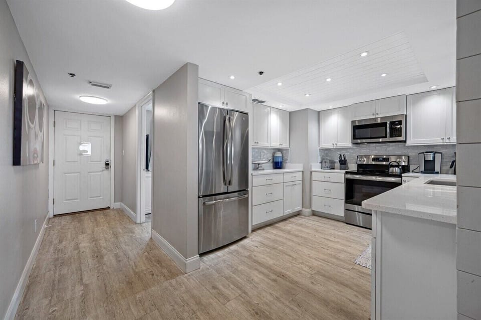 Entryway leads to fully equipped kitchen