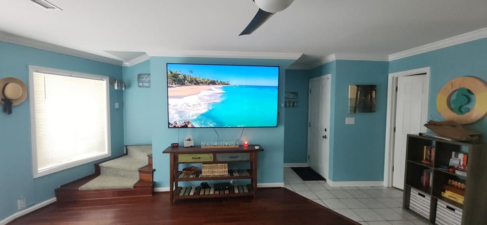 Beach by day, game by night! Catch every game on the 80" screen TV! 