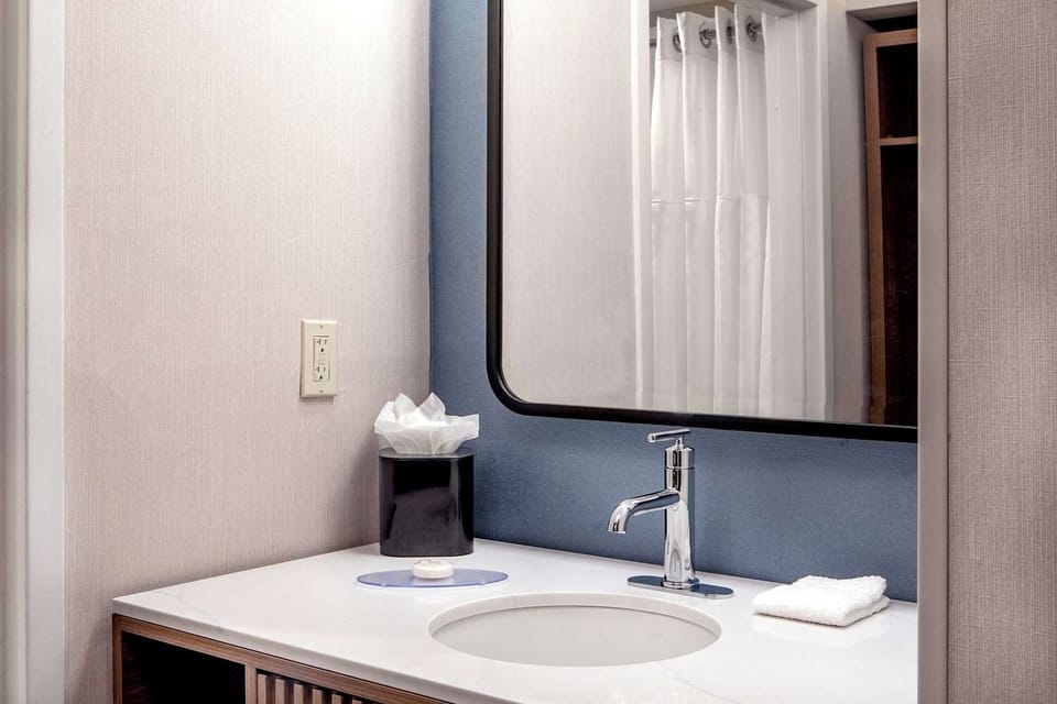 Get ready with sleek fixtures and a clean, modern sink.