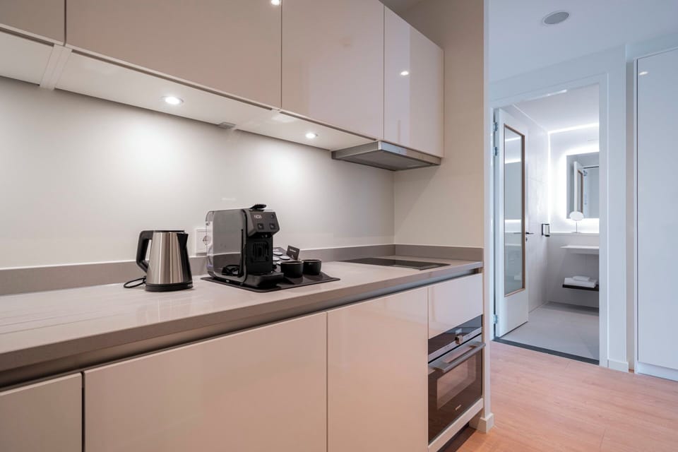 Brew morning coffee in a sleek, fully equipped kitchenette.