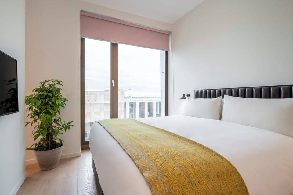 Wake up to soft daylight and a beautifully dressed bed.