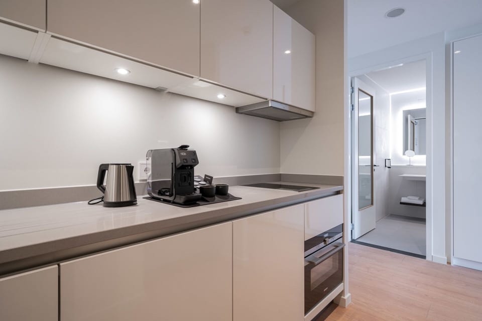 Brew morning coffee in a sleek, fully equipped kitchenette.