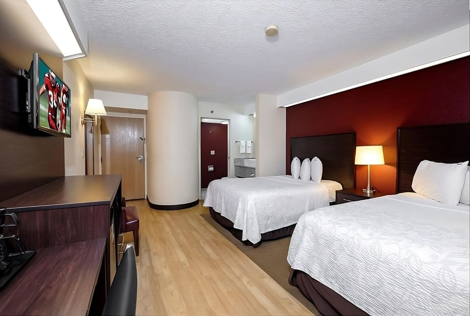 Rest easy with two comfortable beds and warm bedside lighting.