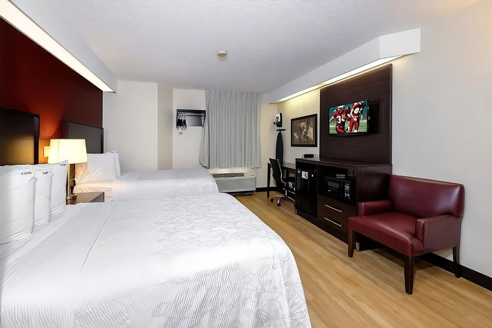 Recharge in a spacious room with TV, fridge, and lounge chair.