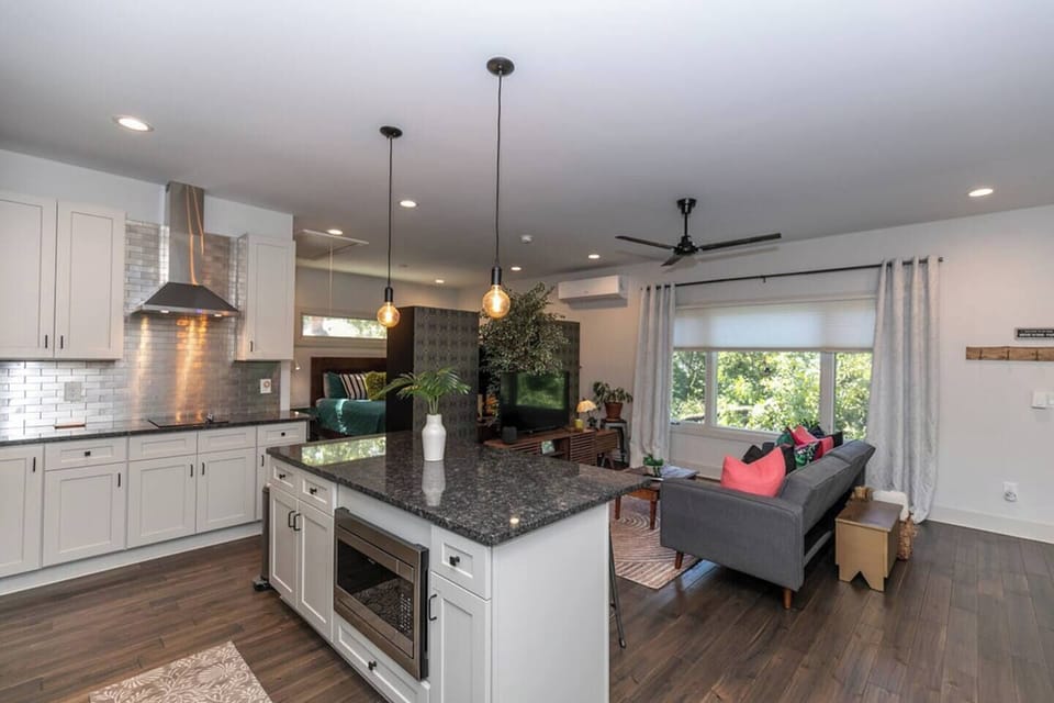 Kitchen view looking toward the living room, highlighting the spacious kitchen island—perfect for meal prep, dining, or gathering with friends.