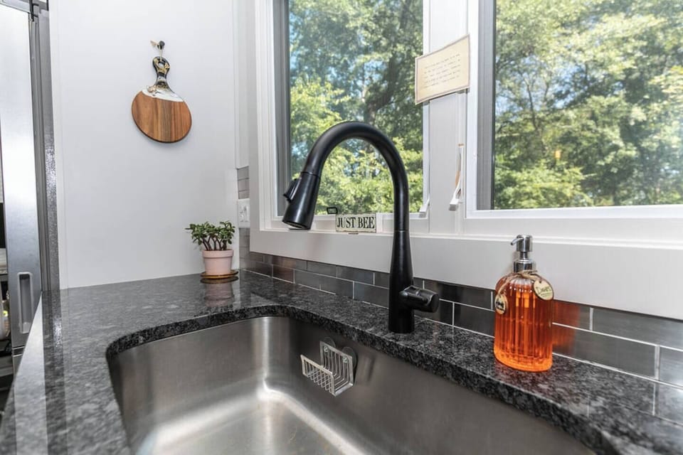 Well-lit sink area with a window view, perfect for daily chores or quick meal prep.
