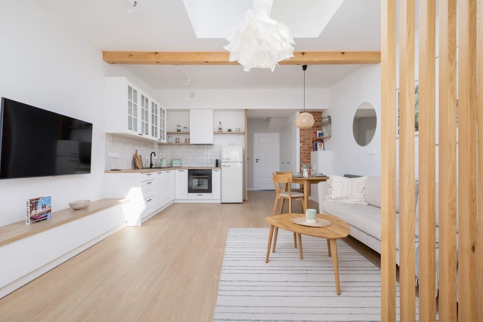 The living area features a sleek coffee table and a flat-screen television.