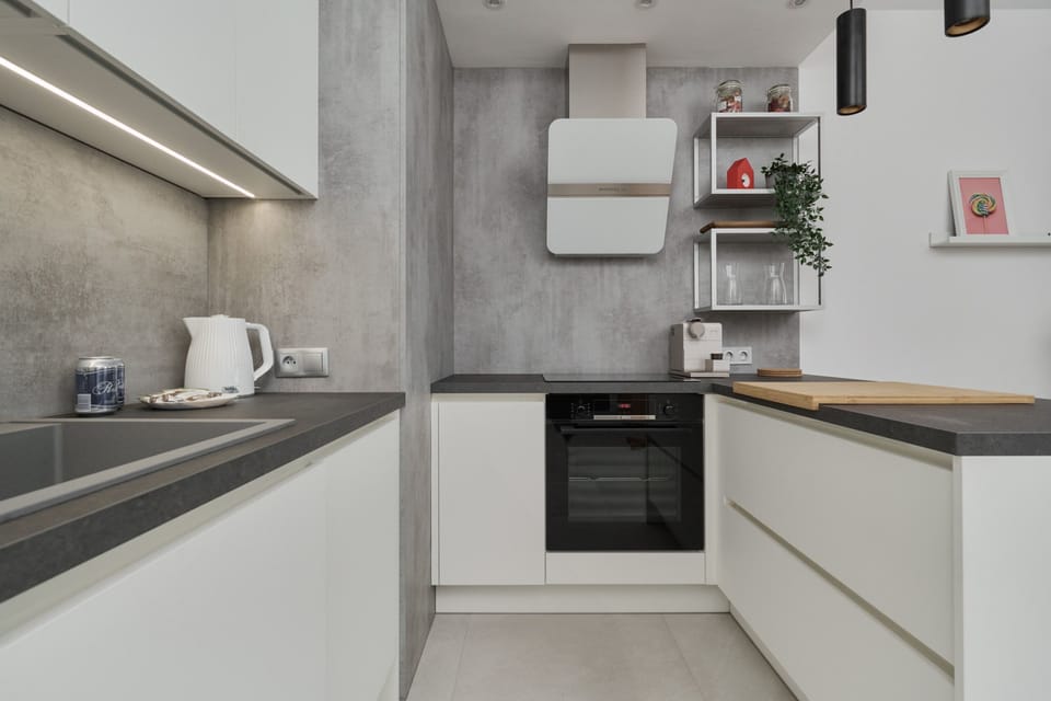 The sleek design of the kitchenette blending seamlessly with the living area.