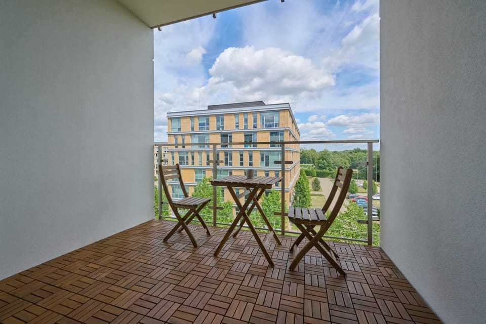 The balcony's stylish design complements the apartment's decor. 