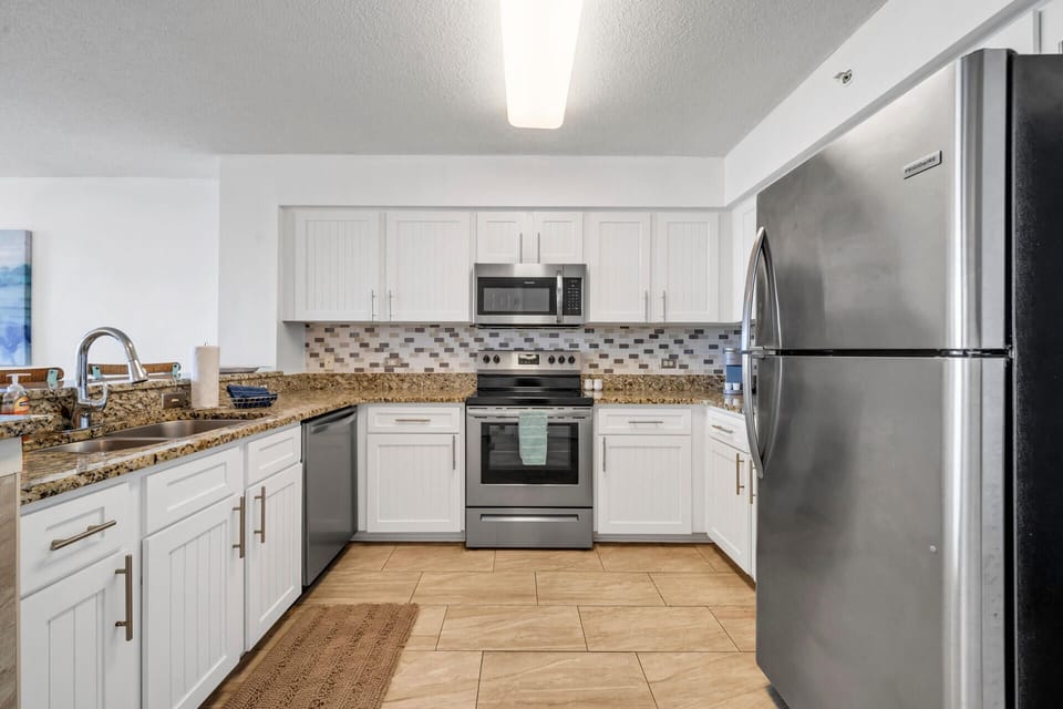 Your fully equipped kitchen features granite countertops, stainless steel appliances, and everything you need to create memorable meals during your stay.