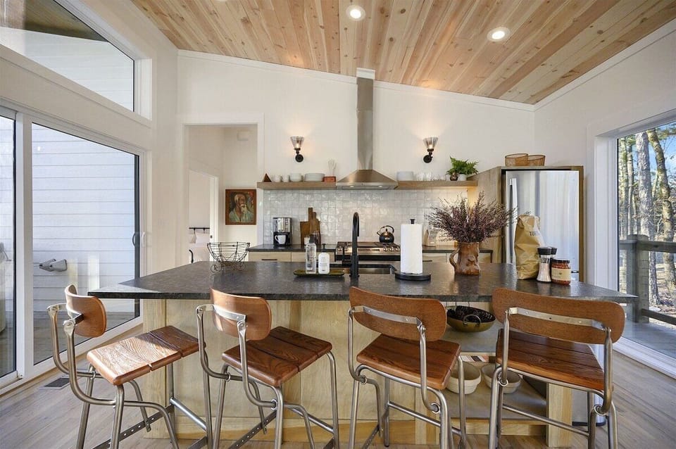Gourmet Kitchen: Craft culinary delights in this stylish space with modern appliances and nature views!
