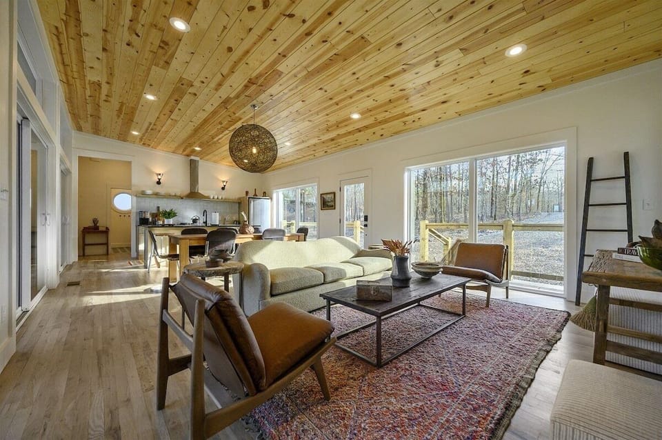 Living Area: Bright and airy space with wood accents, perfect for gatherings and relaxation!
