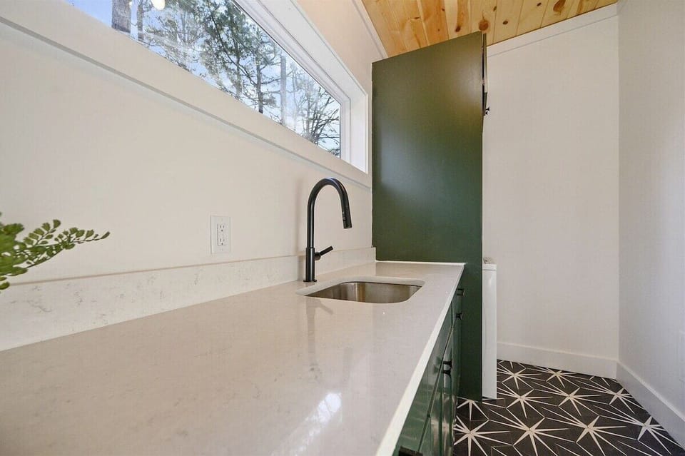 Laundry Room: Modern finishes meet practicality, with stylish décor and views of nature outside!