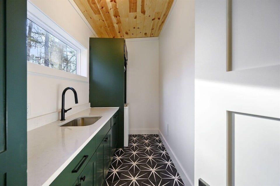 Laundry Room: Sleek design with modern appliances and a stylish patterned floor! Ideal for upkeep!
