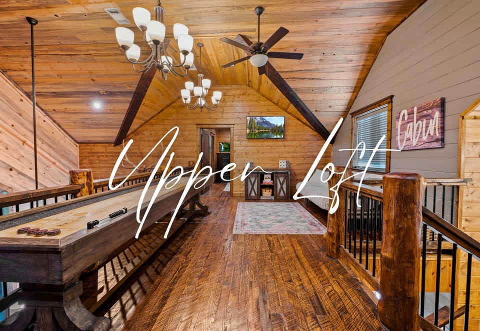 Hallway with hardwood floors and a sturdy staircase leading to an upper level, adorned with a wildlife silhouette art.
