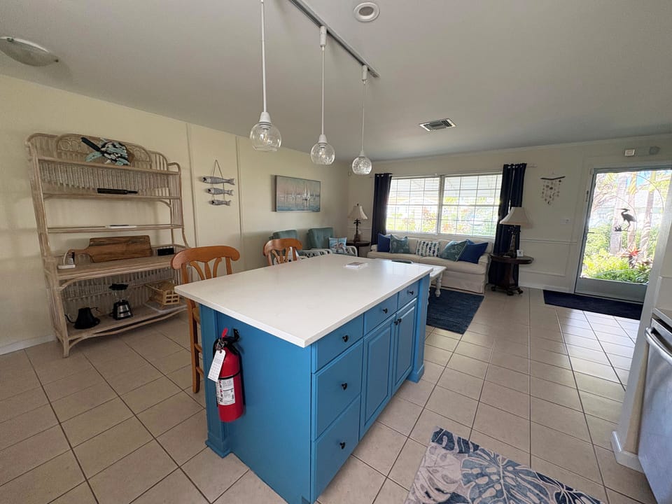 Open kitchen/living area designed for easy movement. Open storage wicker shelves