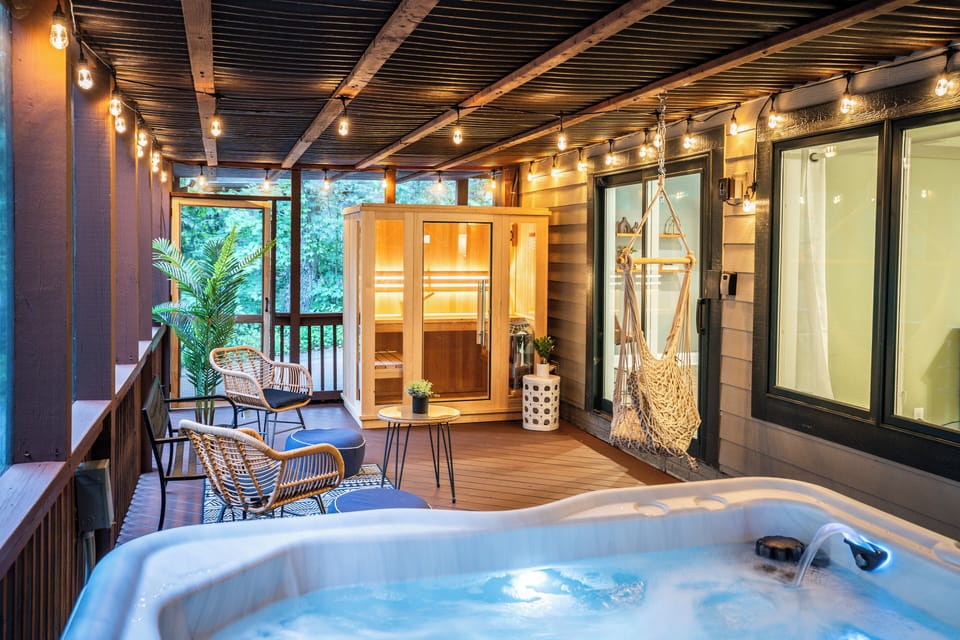 Screened in lower deck with hot tub, 3 person sauna, and seating area
