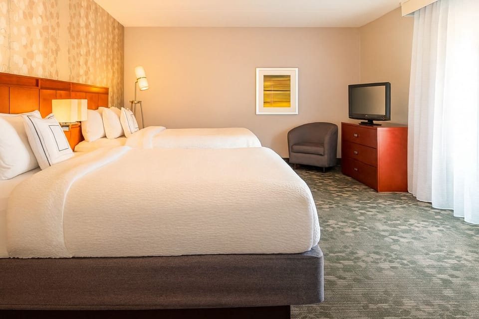 Sink into cozy double beds under warm, relaxing lighting.