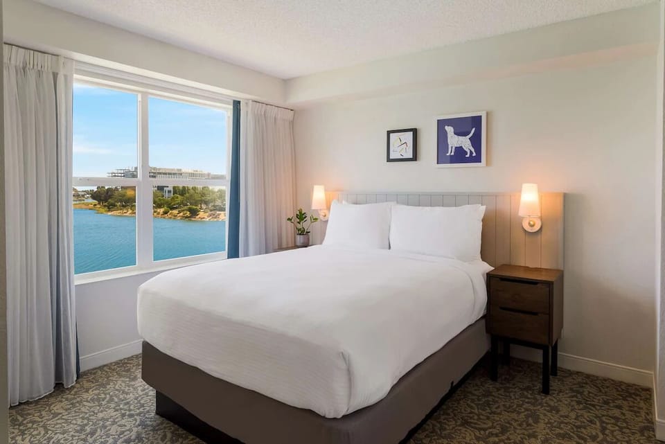 Wake up to serene water views from crisp, plush bedding