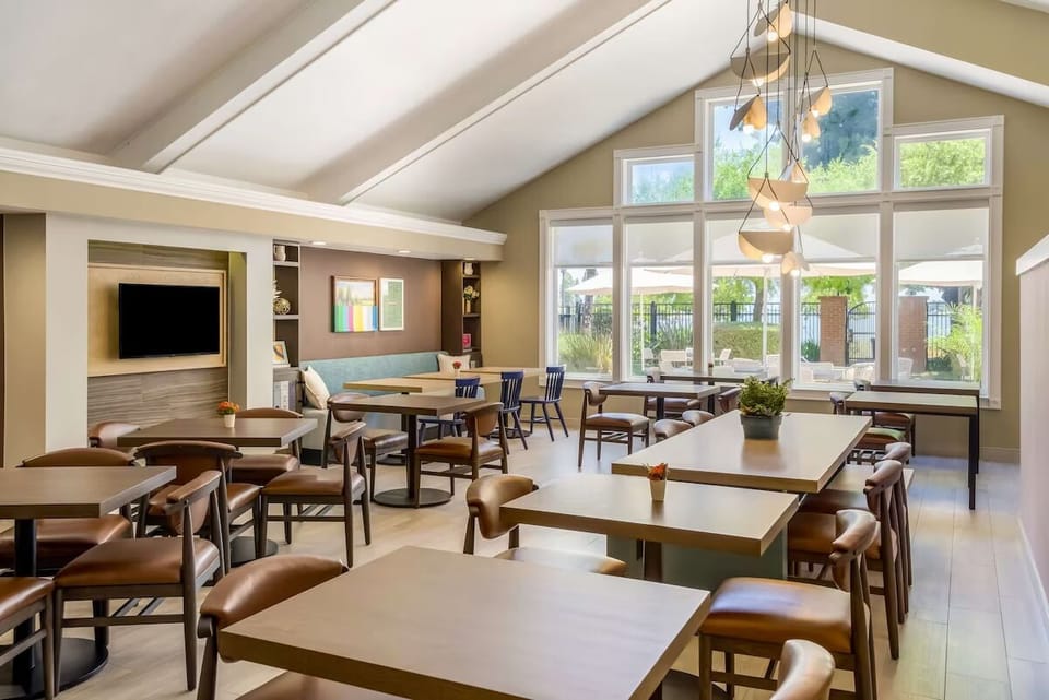 Gather for coffee and conversation in sunlit community lounge.