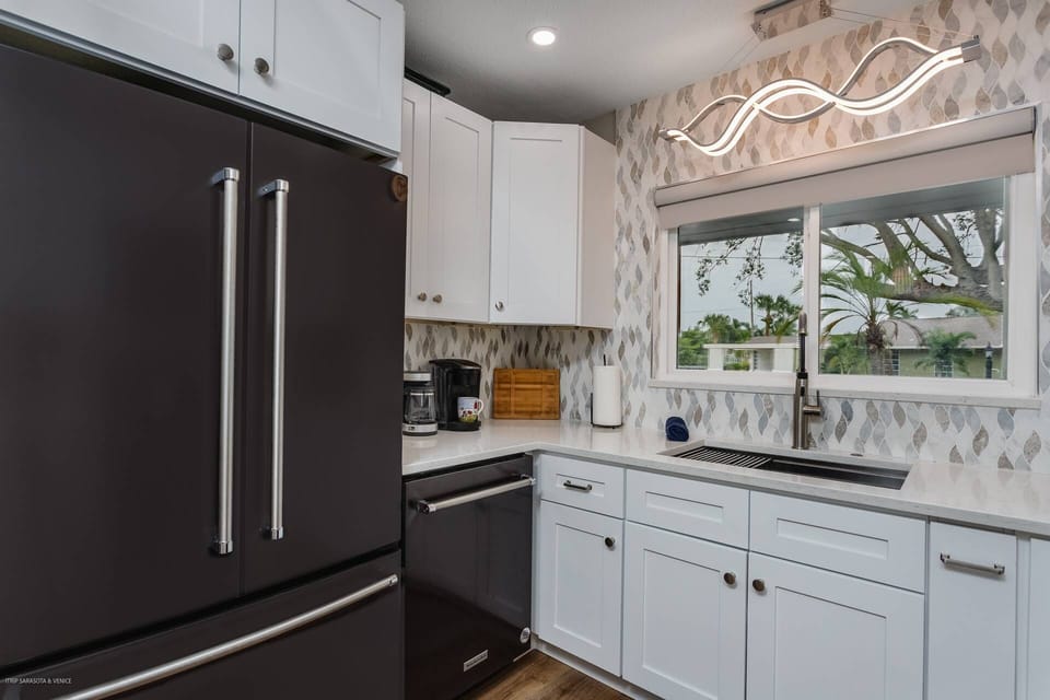 New 3 door KitchenAid refrigerator, dishwasher, Stove and built-in microwave