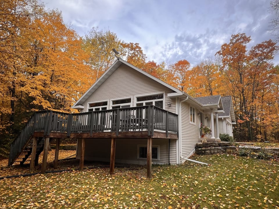 The cottage surrounded by beautiful fall color.