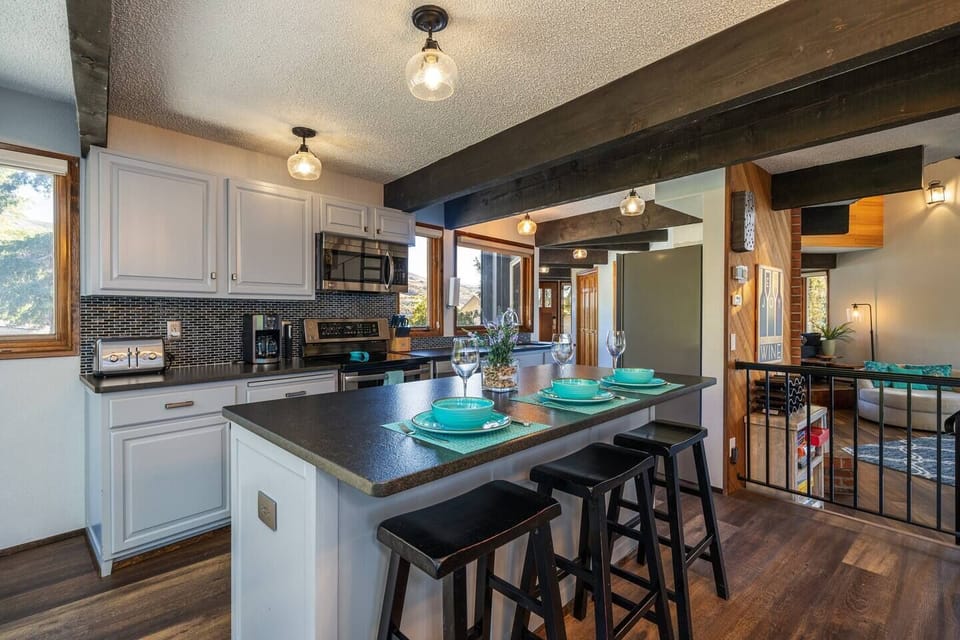 Main floor kitchen with additional dining space @ the island