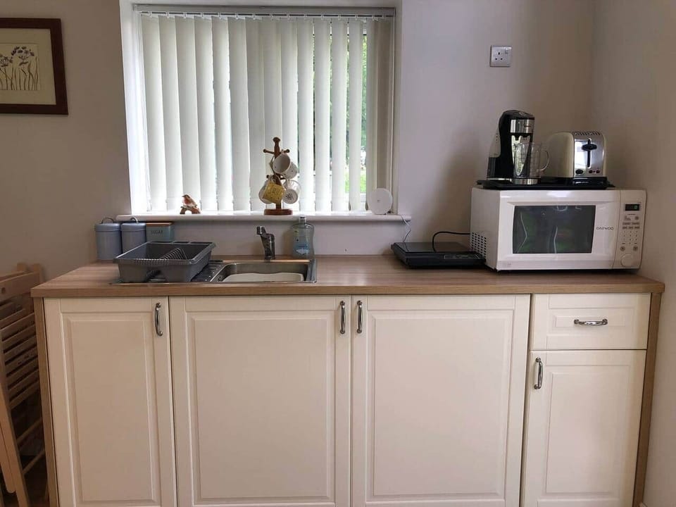 Kitchen Area with Induction Hob, Kettle, Toaster, Microwave and all Pots & Pans, Cutlery, Plates & Glasses etc.