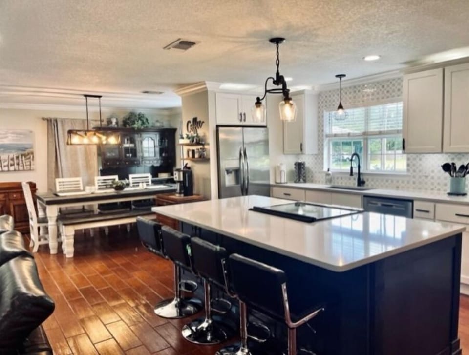 Bar stools are adjustable and comfortable. View of kitchen or turn to tv view
