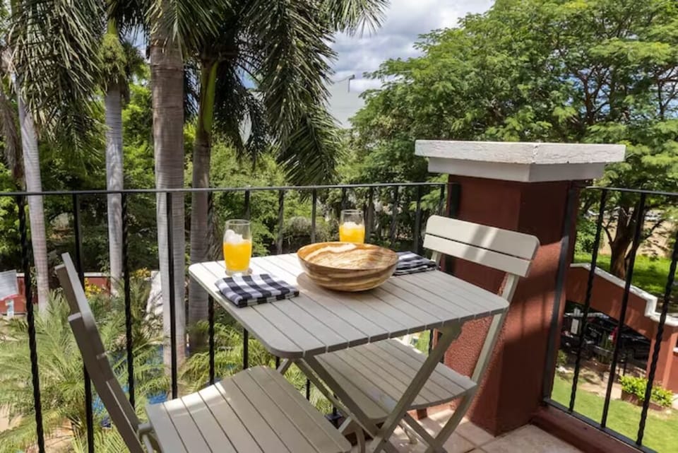 Small balcony next to the living room with a pool view