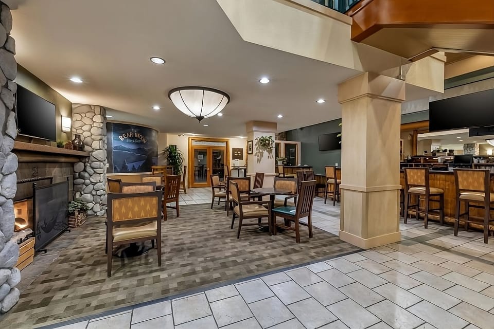 Unwind by the glowing fireplace with cocktails close by.