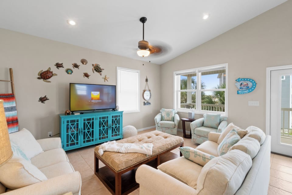 Sink into plush seating while ocean breezes flow through your coastal retreat, complete with charming sea-themed décor and entertainment.