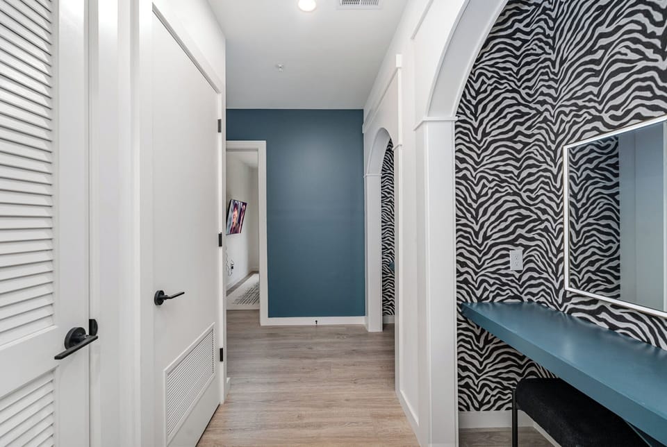 2 Get-Ready Vanities each featuring 2 chairs and a mirror next to the living space.