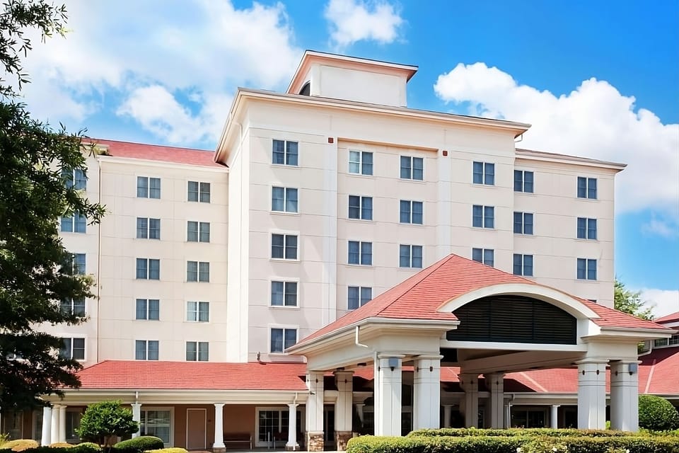 Step into a welcoming stay with a grand arrival facade.
