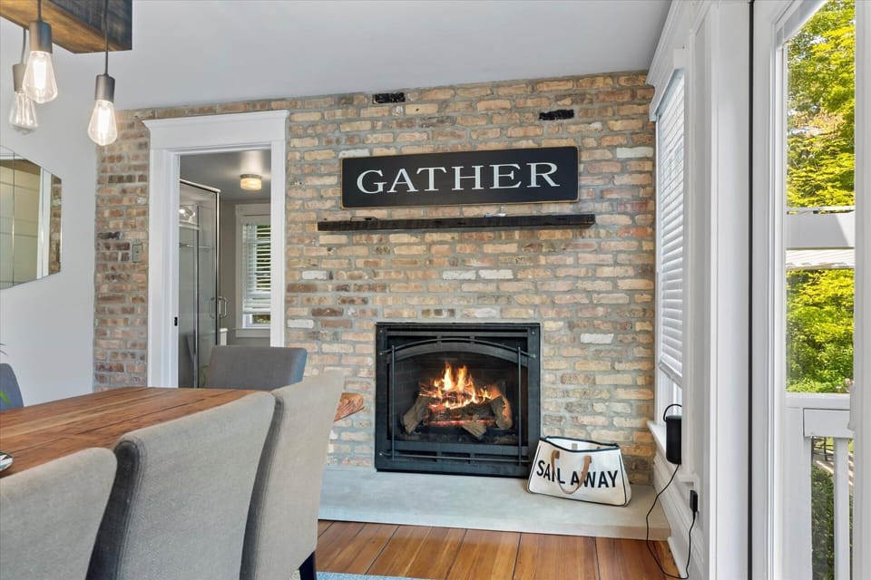 Gather sign above gas fireplace.