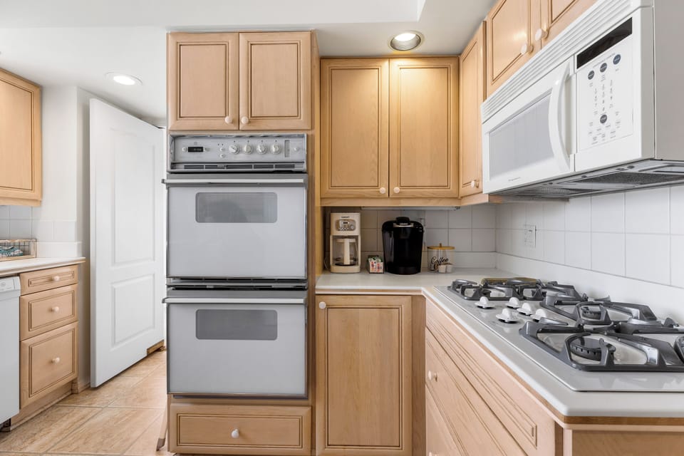 Kitchen: Gas range with 5 burners, microwave, double ovens, drip coffee maker, and Keurig with some starter coffee pods