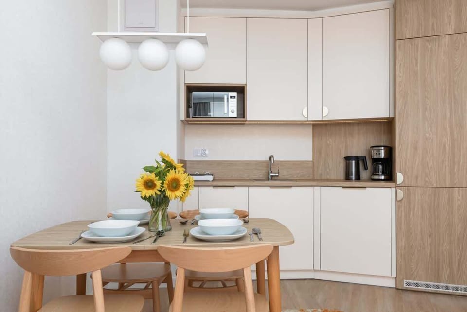 Fully equipped kitchenette with an  induction hob, fridge with freezer, coffee machine, dishwasher, electric kettle and dining area