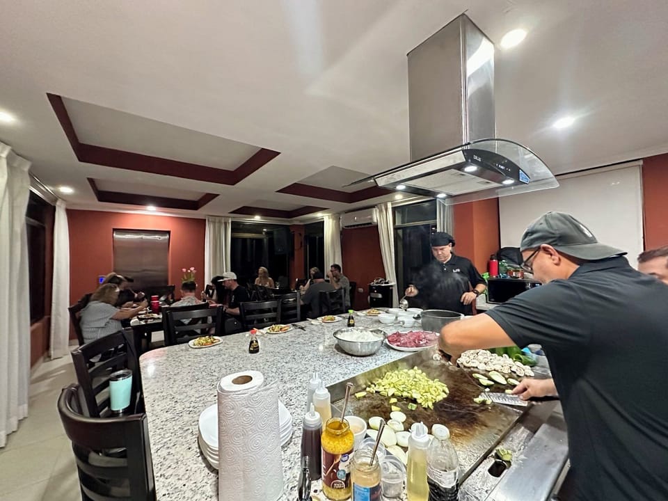 Chefs cooking Teppanyaki at the house..it's like having your own Benihana's