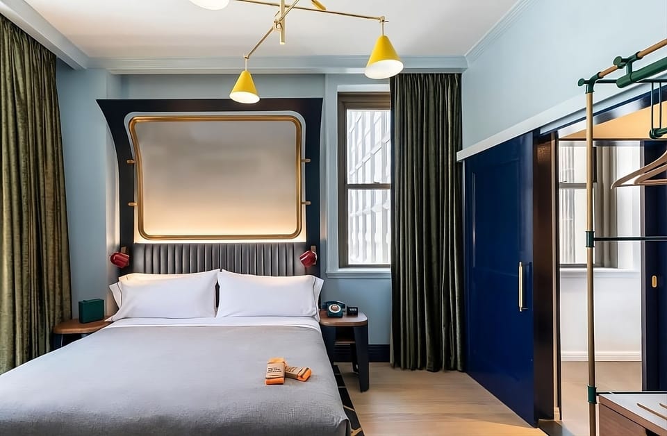 Unwind in a stylish king bed beneath warm designer lighting.