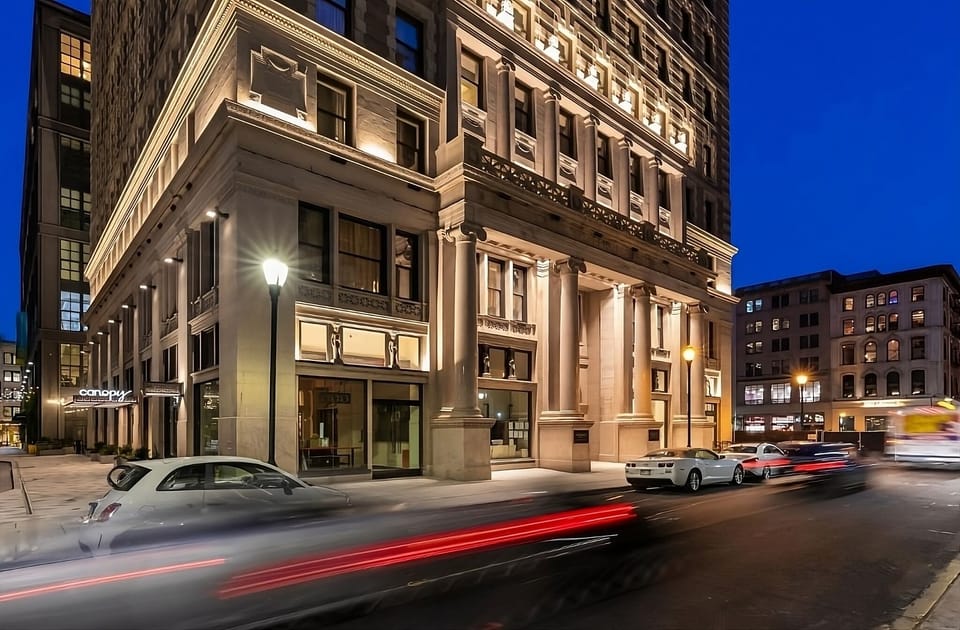 Arrive to a glowing landmark façade in the heart of downtown.