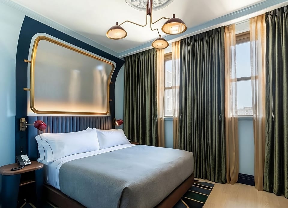 Wake up to city light in a serene, designer king room.