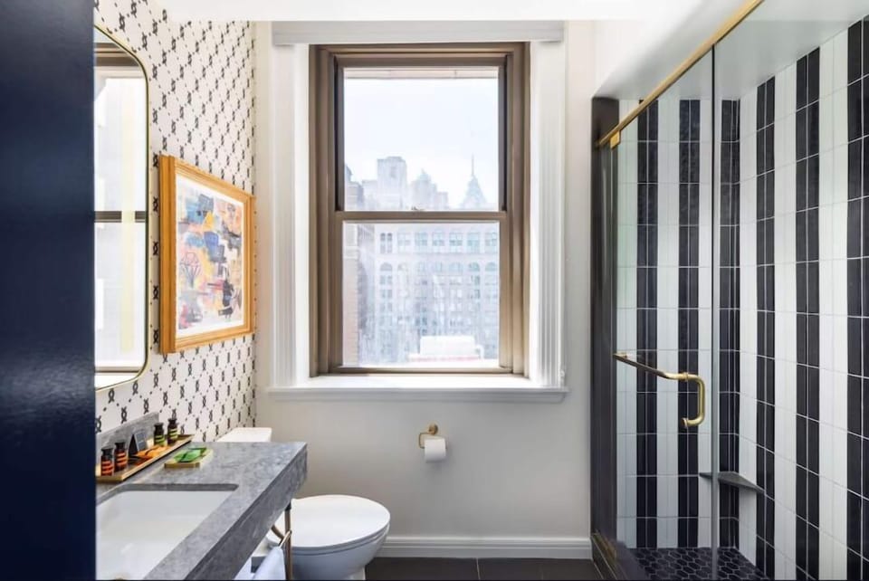 Enjoy skyline glimpses while getting ready in this airy bathroom.