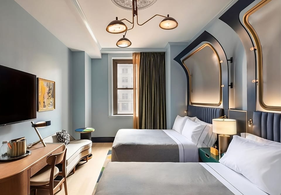 Settle into a spacious double-queen room with warm designer lighting.