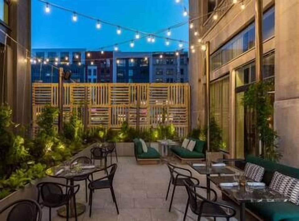 Relax on the patio with evening lights and skyline views.